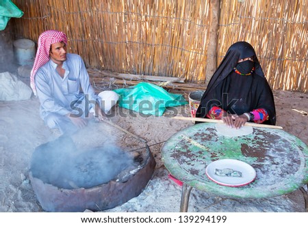 HURGHADA, EGYPT - APR 16, 2013: Unidentified people baking bread in the bedouin village on the desert near Hurghada, April 16, 2013. This Village is one of main tourist attractions on desert in Egypt.