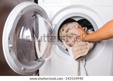 Hand loading laundry to the washing machine