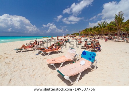 PLAYA DEL CARMEN, MEXICO - JULY 11: Unidentified tourists on the beach of Playacar at Caribbean Sea in Mexico, July 11, 2011. This resort area is popular destination with the most beautiful beaches.