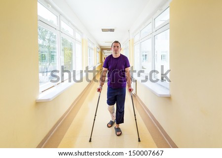 Man walks on crutches after arthroscopic surgery