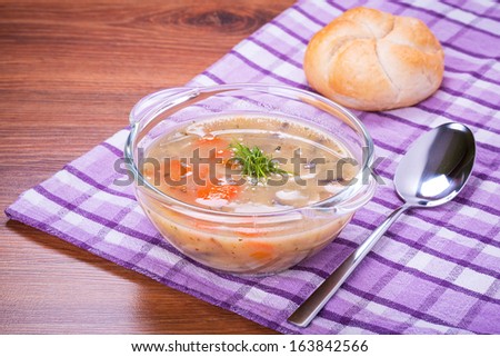 Mushroom soup with bread roll on the table
