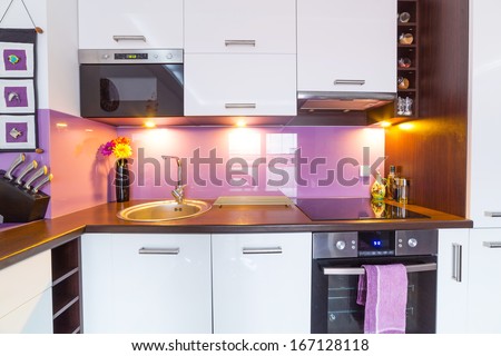Interior of modern white and purple kitchen Interior of modern white and purple kitchen