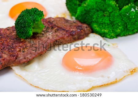 Grilled beef steak with eggs and broccoli