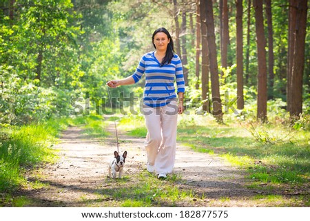 Beautiful brunette on the walk with the dog