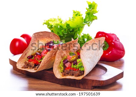 Mexican tacos in tortilla shells with fresh vegetables
