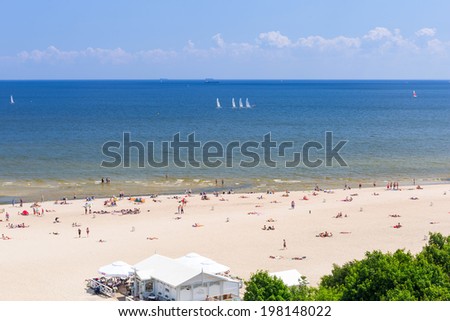 SOPOT, POLAND - 7 JUNE: People on the beach of Sopot at Baltic Sea on 7 June 2014. Sopot is major health and tourist resort destination and has the longest wooden pier in Europe.