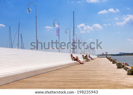 SOPOT, POLAND - 7 JUNE: People on Sopot molo at Baltic Sea, 7 June 2014. Sopot is major health and tourist resort destination and this pier with 511.5 meters long is the longest wooden pier in Europe.