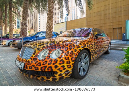 DUBAI, UAE - MARCH 30, 2014: Panther paint Bentley parked outside the Hilton Dubai Hotel on 30 March 2014, UAE. Dubai is one of the richest cities in the world with many luxury cars on streets.