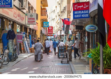 DUBAI, UAE - MARCH 31: People on the street of Deira area in Dubai on 31 March 2014, UAE. Deira is an old commercial center of Dubai with many traditional arabic shops and biggest street market.