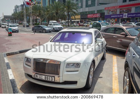 DUBAI, UAE - MARCH 31: Rolls-Royce Ghost on the street of Deira in Dubai on 31 March 2014, UAE. Dubai is one of the richest cities in the world with many luxury cars on streets.