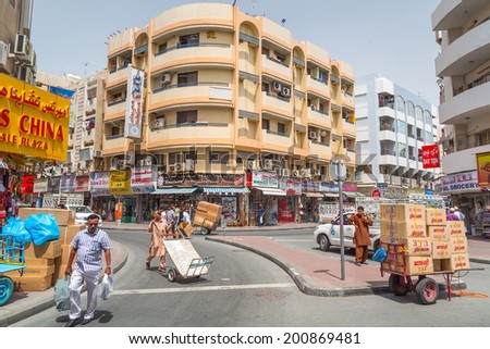 DUBAI, UAE - MARCH 31: People on the street of Deira area in Dubai on 31 March 2014, UAE. Deira is an old commercial center of Dubai with many traditional arabic shops and biggest street market.