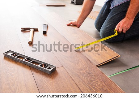 Man installing new laminated wooden floor