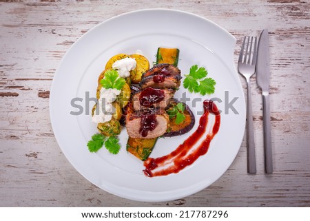 Roasted duck breast with cranberry sauce and vegetables