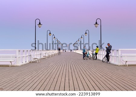 GDYNIA, POLAND - 3 OCTOBER 2014: Baltic pier in Gdynia Orlowo at sunset, Poland. This wooden pier at Baltic sea, long for 180 meters is tourist attraction in Gdynia.