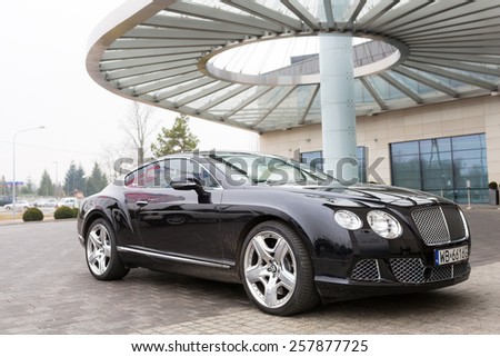 WARSAW, POLAND - 28 FEBRUARY 2014: Bentley Continental GT parked at the DoubleTree by Hilton Hotel & Conference Centre in Warsaw, Poland. Hilton has over 400 hotels and resorts around the world.