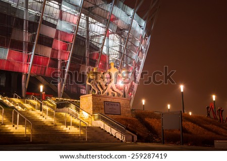 WARSAW, POLAND - 27 FEBRUARY 2014: National Stadium in Warsaw illuminated at night by national colors, Poland. The National Stadium is a retractable roof football stadium for 58 145 spectators.