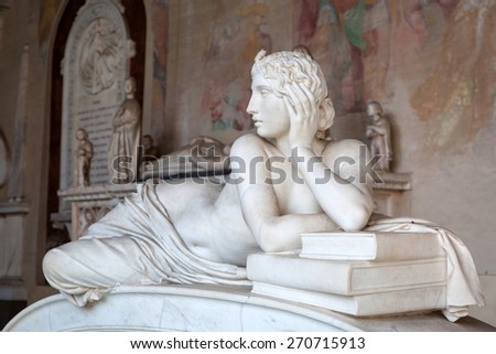 PISA, ITALY - APRIL 11, 2015: Tomb sculptures in the Monumental Cemetery at the Leaning Tower of Pisa, Italy. Pisa is a city in Tuscany known worldwide for the Leaning Tower landmark.