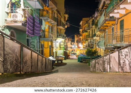 MANAROLA, ITALY - APRIL 11, 2015: Narrow streets of Manarola village at night in Italy. Manarola is one of five famous coastline villages in the Cinque Terre National Park at the Ligurian sea.