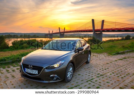 POLAND-SEPTEMBER 14, 2014: New Mazda 3 captured at sunset near Vistula river with HDR technique. Mazda 3 is a popular compact car manufactured in Japan by the Mazda Motor Corporation.
