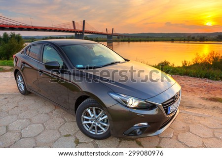 POLAND-SEPTEMBER 14, 2014: New Mazda 3 captured at sunset near Vistula river with HDR technique. Mazda 3 is a popular compact car manufactured in Japan by the Mazda Motor Corporation.