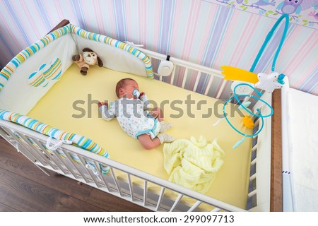 Baby twins room with pastel wallpapers and white cradles
