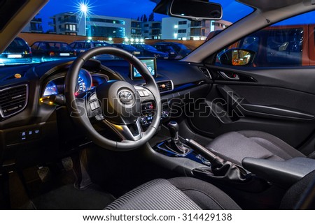 POLAND-SEPTEMBER 24, 2014: Interior of new Mazda 3 captured at dusk with long exposure technique. Mazda 3 is a popular compact car manufactured in Japan by the Mazda Motor Corporation.
