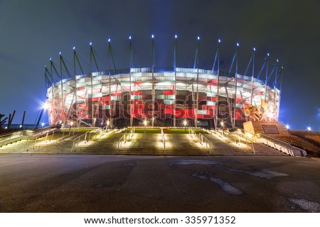 WARSAW, POLAND - 27 FEBRUARY 2014: National Stadium in Warsaw illuminated at night by national colors, Poland. The National Stadium is a retractable roof football stadium for 58 145 spectators.