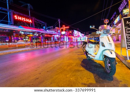 LAGANAS, GREECE - AUG 24, 2015: Main street of the Laganas town at night on Zakynthos, Greece. Laganas is a very popular holidays destination full of nightclubs, bars, restaurants and souvenir shops.