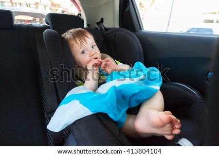 Baby boy in the car on child safety seat