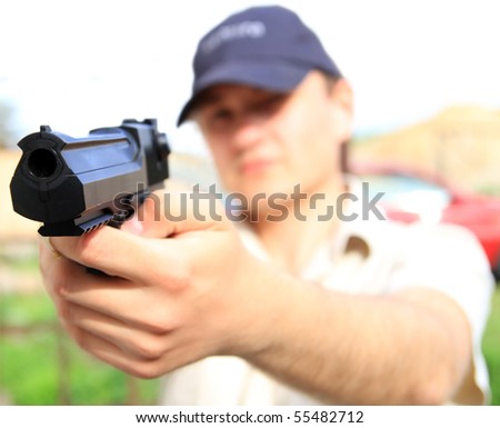 Young man holding gun