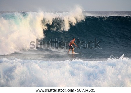 HUDHURANFUSHI ISLAND, MALDIVES - JUNE 29: Unidentified man surfing on huge wave of Indian Ocean of Maldives on 29 June 2009 Hudhuranfushi island is very popular place for surfers from over the world.