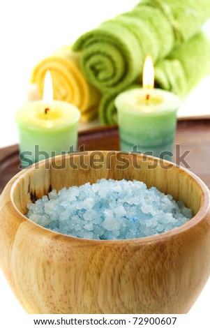 Spa towels with candles isolated on white