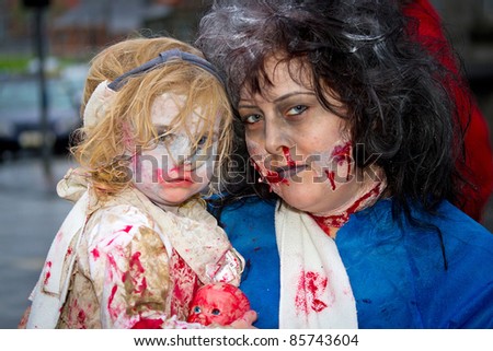 LIMERICK, IRELAND - OCTOBER 1:  Portrait of unidentified woman with child in zombie costumes on the street of Outbreak Limerick Zombie Festival on October 1st, 2011 in Limerick, Ireland