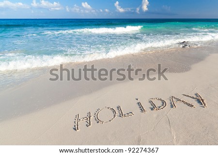 Holiday sign on the beach of Caribbean Sea in Mexico