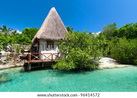 Idyllic Mexican jungle scenery with hut on the water