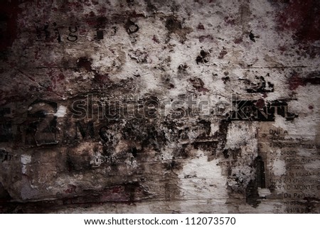 Grunge textured background with old torn newspapers.