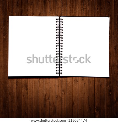 Black notebook on a wood background
