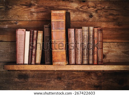 grunge wooden shelf with old books.