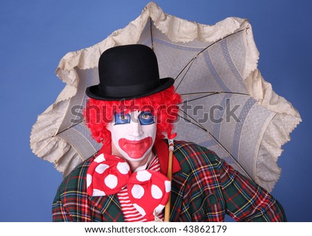 funny red haired clown with umbrella