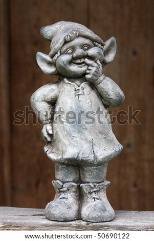 Funny dwarf, gnome with brown background
