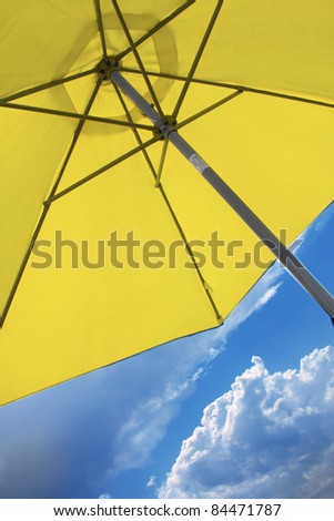 yellow umbrella on blue sky background.