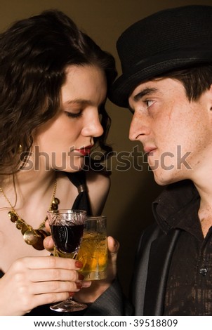 man and woman drink alcohol in retro bar