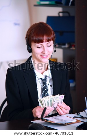 happy businesswoman in office count money