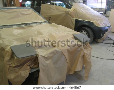 Two cars made ready for a paint job.