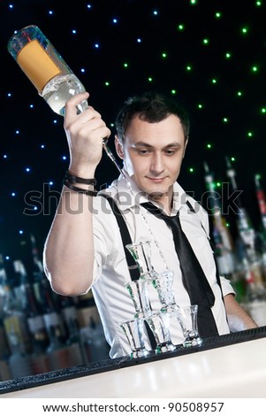 Bartender  is pouring a drink