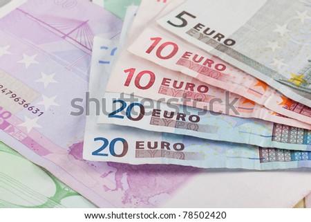 Several Euro banknotes of lower denominations, the European Union currency. Displayed here are banknotes of 5, 10, and 20 Euros.