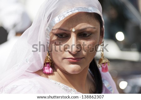 CREMONA - APRIL 13: young woman of the Sikh religion in procession through the spring festival Vaisakhi, April 13, 2013 in Cremona, Lombardia, Italy. the Sikh festival takes place every year.