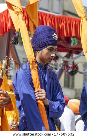 CREMONA - APRIL 13: young boy of the Sikh religion in procession through the spring festival Vaisakhi, April 13, 2013 in Cremona, Lombardia, Italy. the Sikh festival takes place every year.