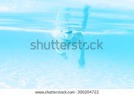 young man swimming the front crawl style in a pool