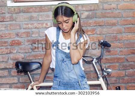 young beautiful woman enjoys music with headphones
